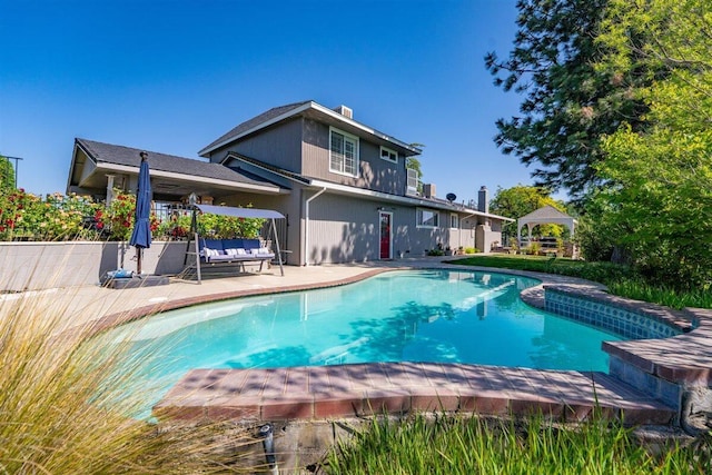 outdoor pool featuring a gazebo and a patio
