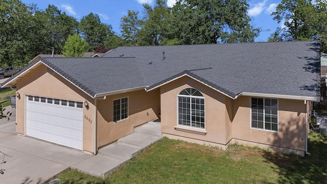 view of front of property with a garage, stucco siding, and concrete driveway