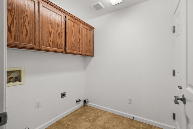 laundry area featuring gas dryer hookup, baseboards, electric dryer hookup, cabinet space, and washer hookup
