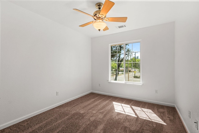 unfurnished room featuring carpet, visible vents, baseboards, and ceiling fan