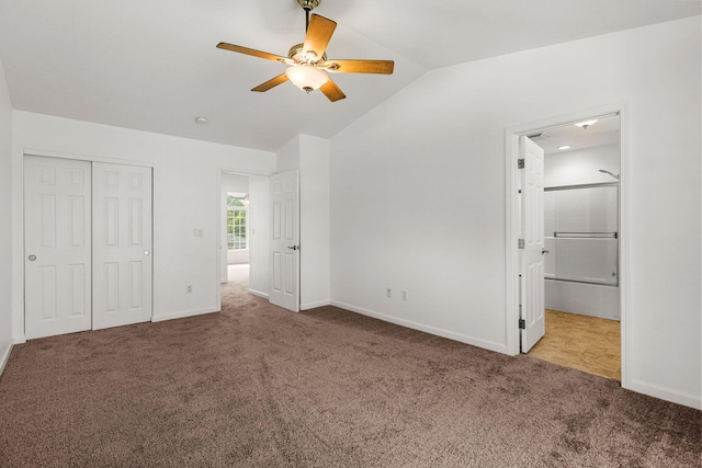 unfurnished bedroom featuring baseboards, carpet floors, vaulted ceiling, and a closet