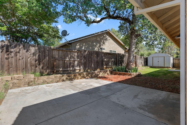 view of patio with a storage shed, a fenced backyard, and an outdoor structure