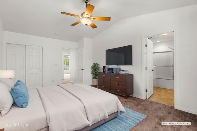 bedroom featuring vaulted ceiling, a ceiling fan, a closet, connected bathroom, and carpet