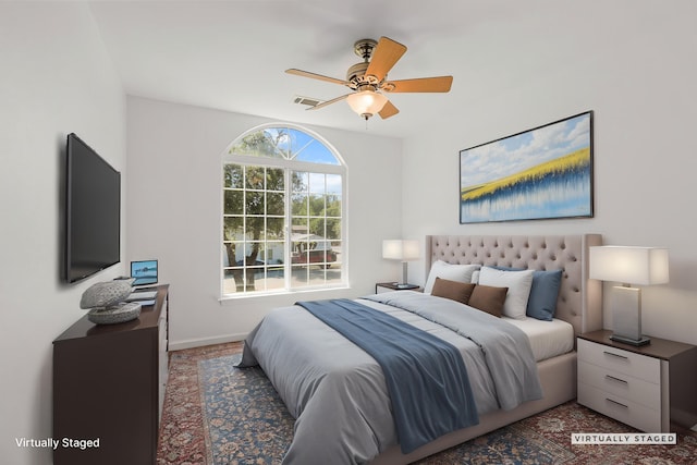 bedroom featuring visible vents, a ceiling fan, and baseboards