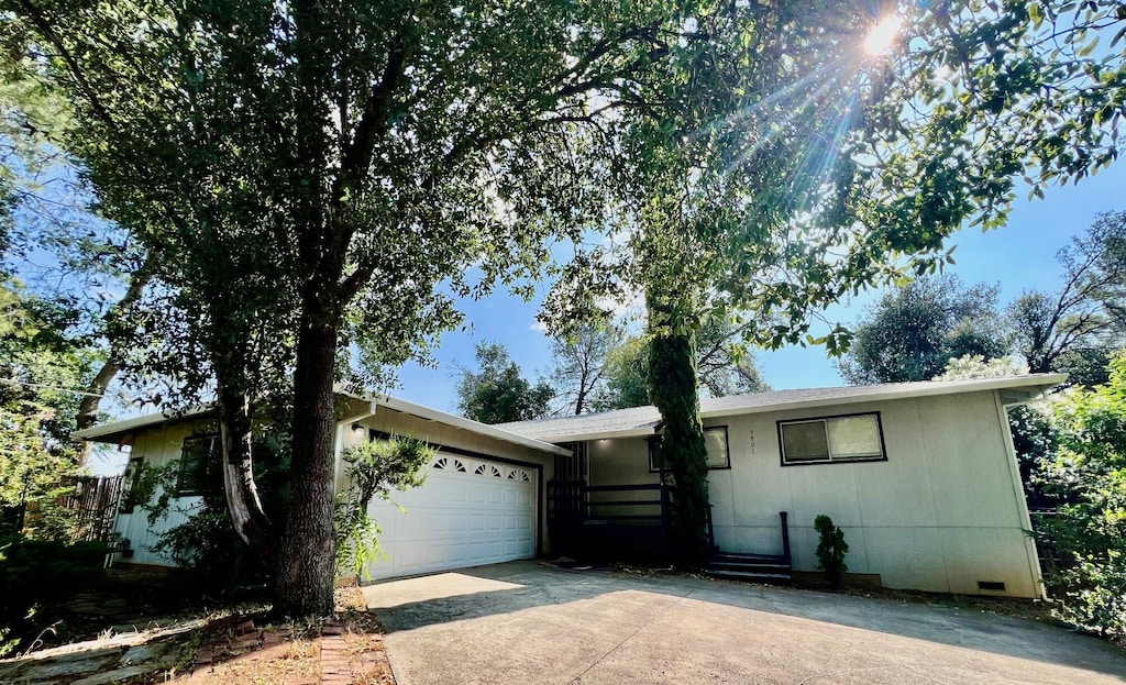 3901 El Portal Dr, Redding, CA 96002 - ranch-style house featuring concrete driveway, an attached garage, and crawl space