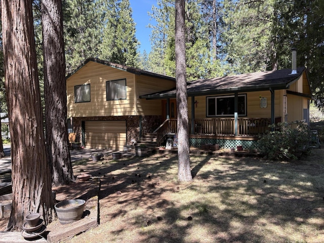 37150 Sapphire Rd, Burney, CA 96013 - tri-level home featuring a garage and covered porch