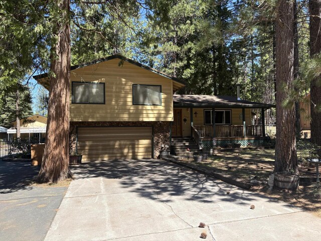 37150 Sapphire Rd, Burney, CA 96013 - tri-level home featuring covered porch, an attached garage, and concrete driveway
