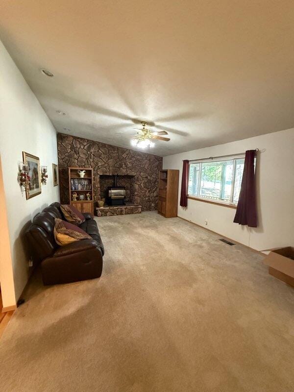 37150 Sapphire Rd, Burney, CA 96013 - living area featuring carpet floors, a fireplace, and a ceiling fan