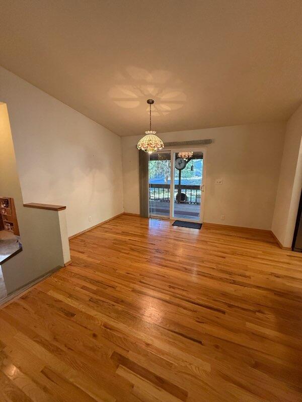 37150 Sapphire Rd, Burney, CA 96013 - unfurnished dining area featuring a chandelier and light wood finished floors