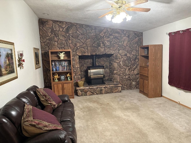 37150 Sapphire Rd, Burney, CA 96013 - living area featuring a wood stove, carpet floors, a textured ceiling, and a ceiling fan