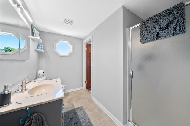 bathroom with visible vents, vanity, a stall shower, and toilet