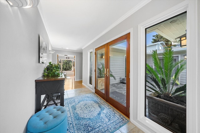 doorway to outside with light tile patterned flooring, crown molding, baseboards, and french doors