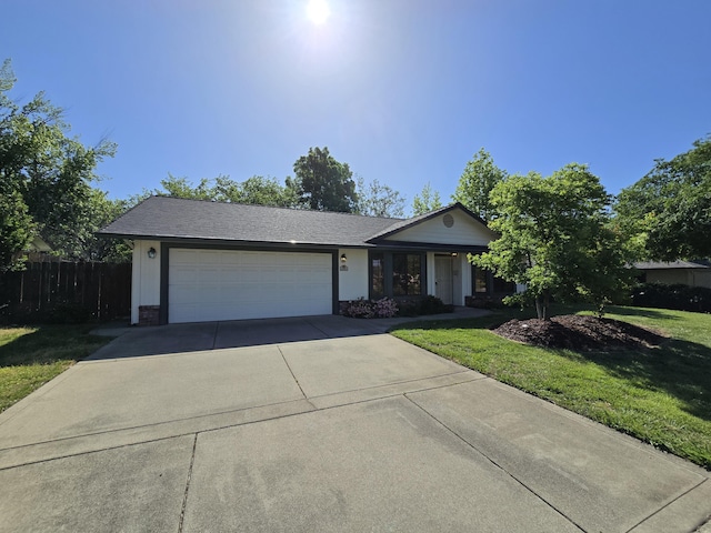 3671 Santa Rosa Way, Redding, CA 96003 - single story home with concrete driveway, an attached garage, fence, and a front lawn