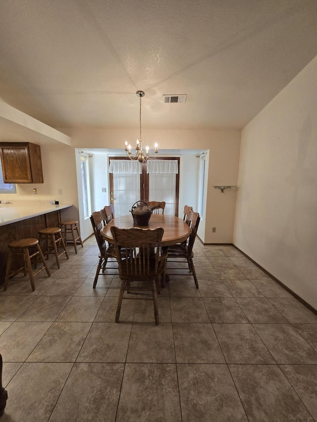 3671 Santa Rosa Way, Redding, CA 96003 - tiled dining area with baseboards, a chandelier, and visible vents