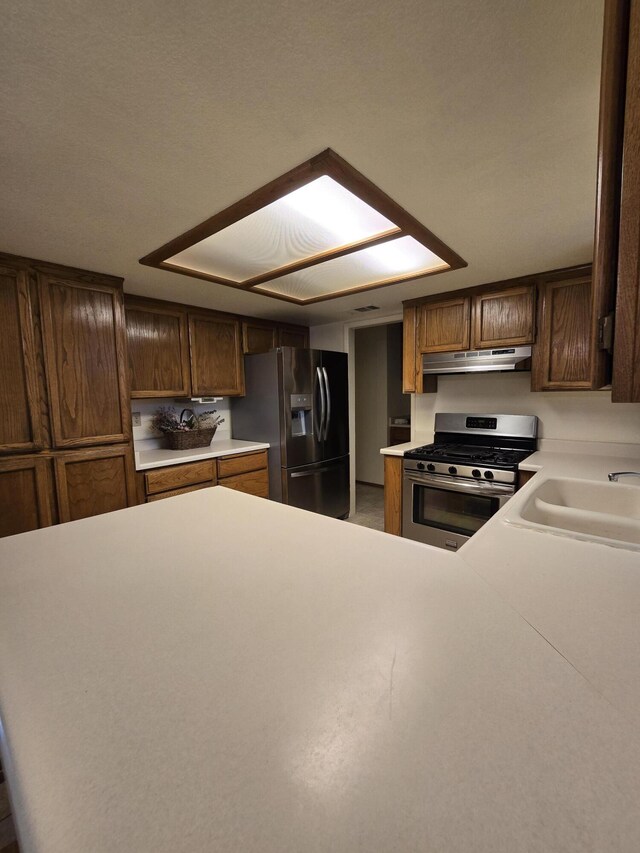 3671 Santa Rosa Way, Redding, CA 96003 - kitchen with under cabinet range hood, stainless steel appliances, light countertops, and a sink