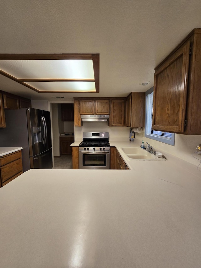 3671 Santa Rosa Way, Redding, CA 96003 - kitchen with light countertops, under cabinet range hood, stainless steel appliances, and a sink