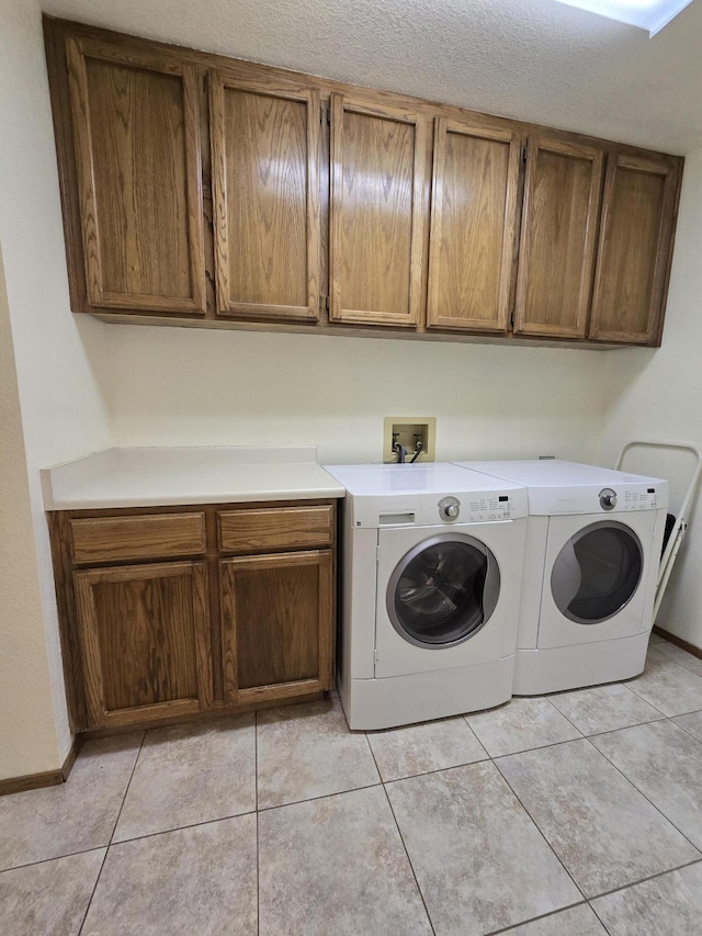 3671 Santa Rosa Way, Redding, CA 96003 - clothes washing area featuring baseboards, cabinet space, light tile patterned flooring, and independent washer and dryer