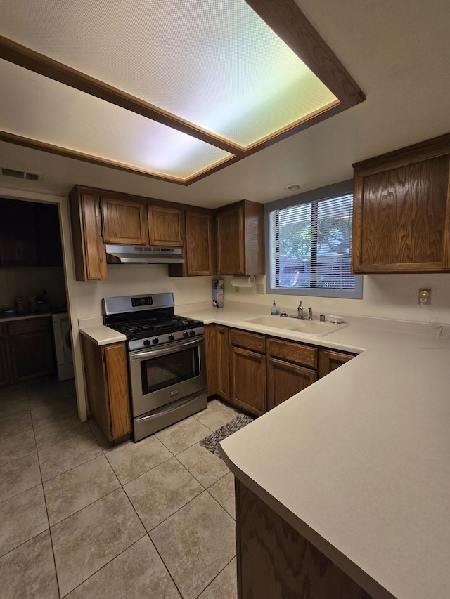 3671 Santa Rosa Way, Redding, CA 96003 - kitchen featuring under cabinet range hood, light countertops, a sink, light tile patterned flooring, and gas stove