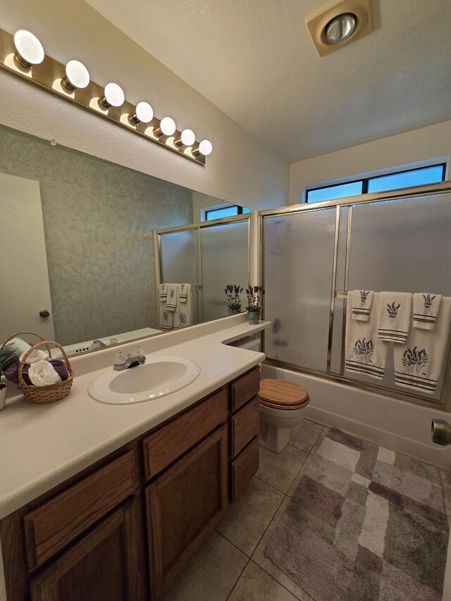 3671 Santa Rosa Way, Redding, CA 96003 - bathroom featuring tile patterned floors, a textured ceiling, bath / shower combo with glass door, toilet, and vanity