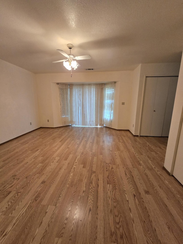 3671 Santa Rosa Way, Redding, CA 96003 - spare room featuring a textured ceiling, visible vents, baseboards, wood finished floors, and ceiling fan