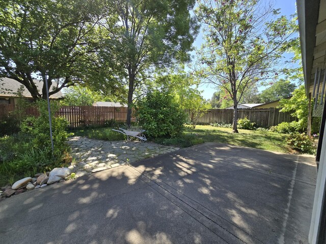3671 Santa Rosa Way, Redding, CA 96003 - wooden terrace featuring a fenced backyard, a yard, and a patio area