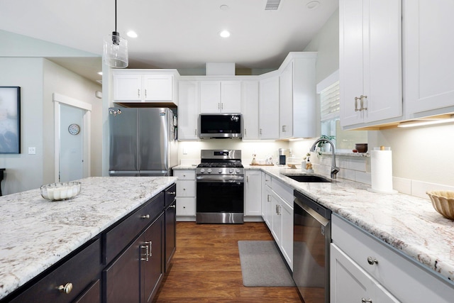 22070 Lassen View Dr, Palo Cedro, CA 96073 - kitchen with light stone counters, white cabinetry, stainless steel appliances, and a sink