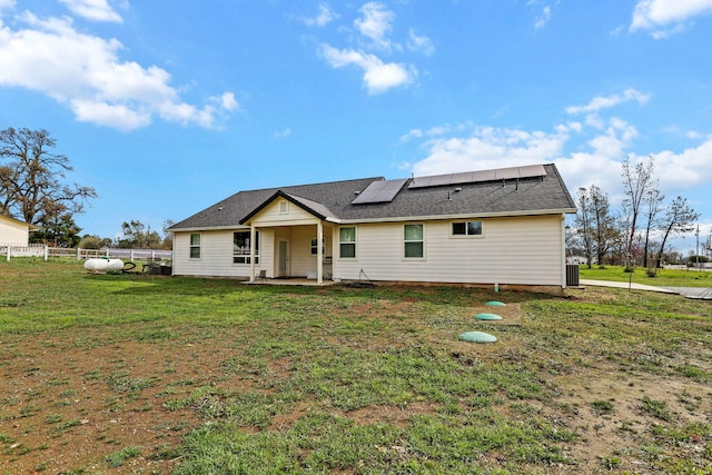 22070 Lassen View Dr, Palo Cedro, CA 96073 - rear view of house with central air condition unit, fence, a yard, roof mounted solar panels, and a patio