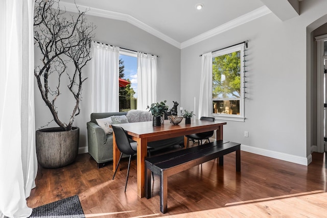 dining area featuring crown molding, arched walkways, baseboards, wood finished floors, and lofted ceiling
