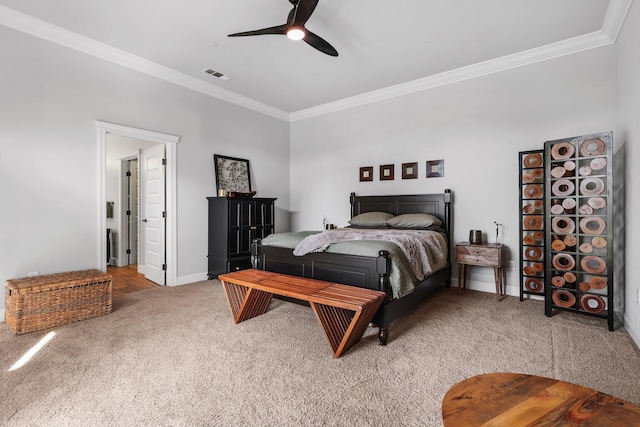 bedroom with visible vents, ornamental molding, baseboards, ceiling fan, and light colored carpet
