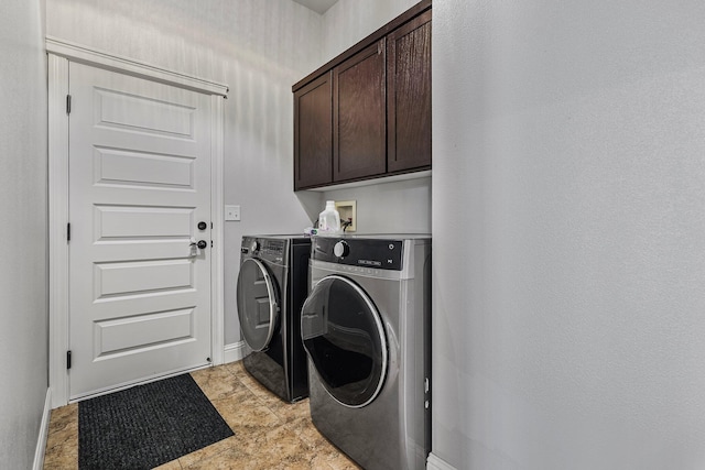 laundry room featuring baseboards, cabinet space, and independent washer and dryer