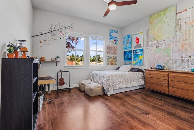 bedroom with baseboards, ceiling fan, and wood finished floors