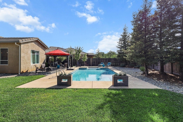 view of swimming pool with a lawn, a patio, a gazebo, and a fenced in pool
