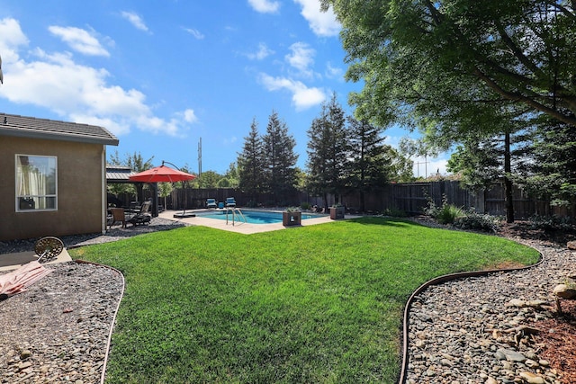 view of yard with a fenced backyard, a fenced in pool, and a patio