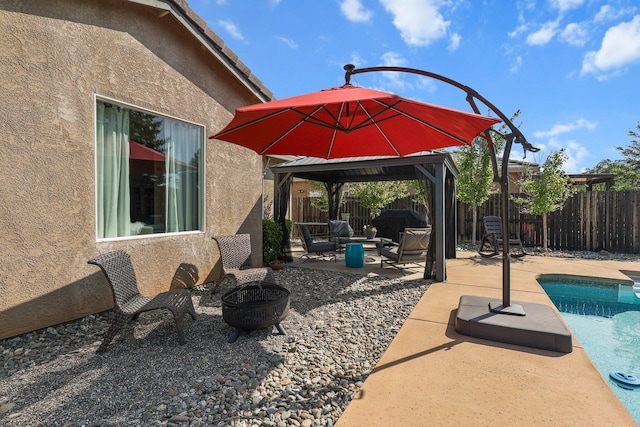 view of patio featuring a gazebo, a fenced backyard, a fire pit, and a fenced in pool
