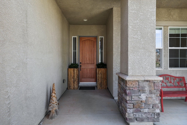 doorway to property with stucco siding