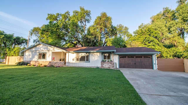single story home with concrete driveway, an attached garage, brick siding, and fence
