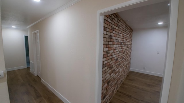 hall featuring brick wall, ornamental molding, wood finished floors, and recessed lighting