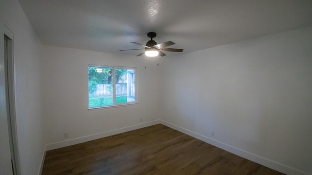 unfurnished room featuring ceiling fan, baseboards, wood finished floors, and visible vents