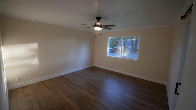 empty room with ceiling fan, baseboards, ornamental molding, and wood finished floors