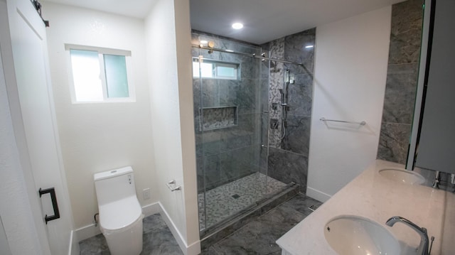 full bath with a sink, double vanity, toilet, a stall shower, and baseboards