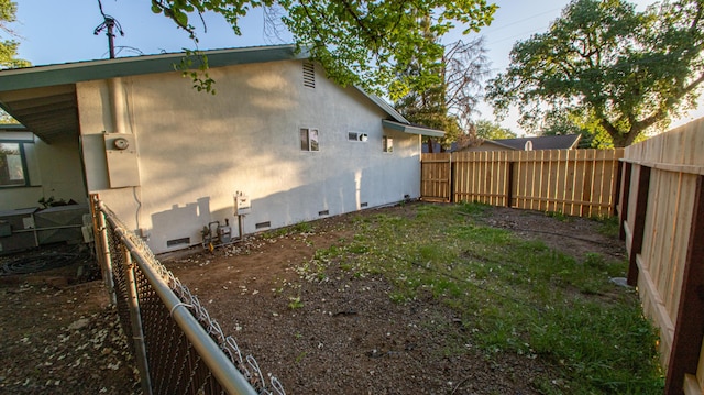 view of property exterior with a fenced backyard, crawl space, and stucco siding