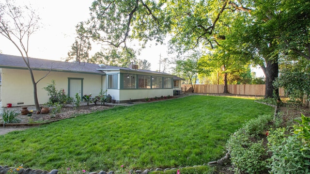 view of yard featuring a sunroom and fence