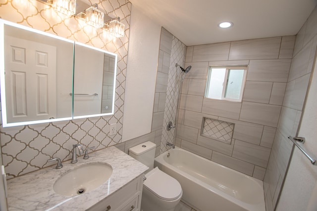 bathroom with toilet, vanity, tub / shower combination, and recessed lighting
