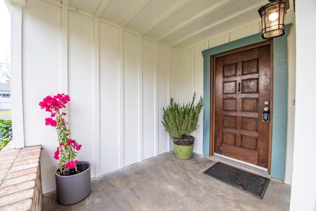 view of exterior entry featuring board and batten siding