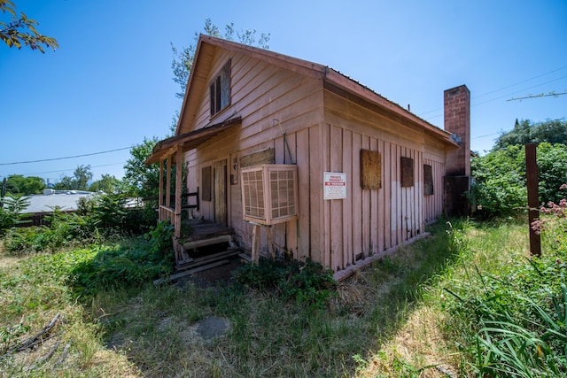 1868 Gold St, Redding, CA 96001 - view of side of property featuring board and batten siding and a chimney