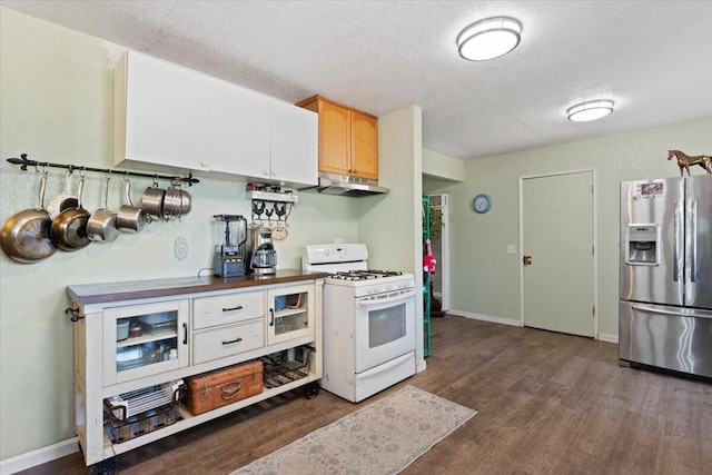 19715 Reed Rd, Cottonwood, CA 96022 - kitchen with stainless steel fridge with ice dispenser, white gas range oven, under cabinet range hood, dark wood finished floors, and a textured ceiling