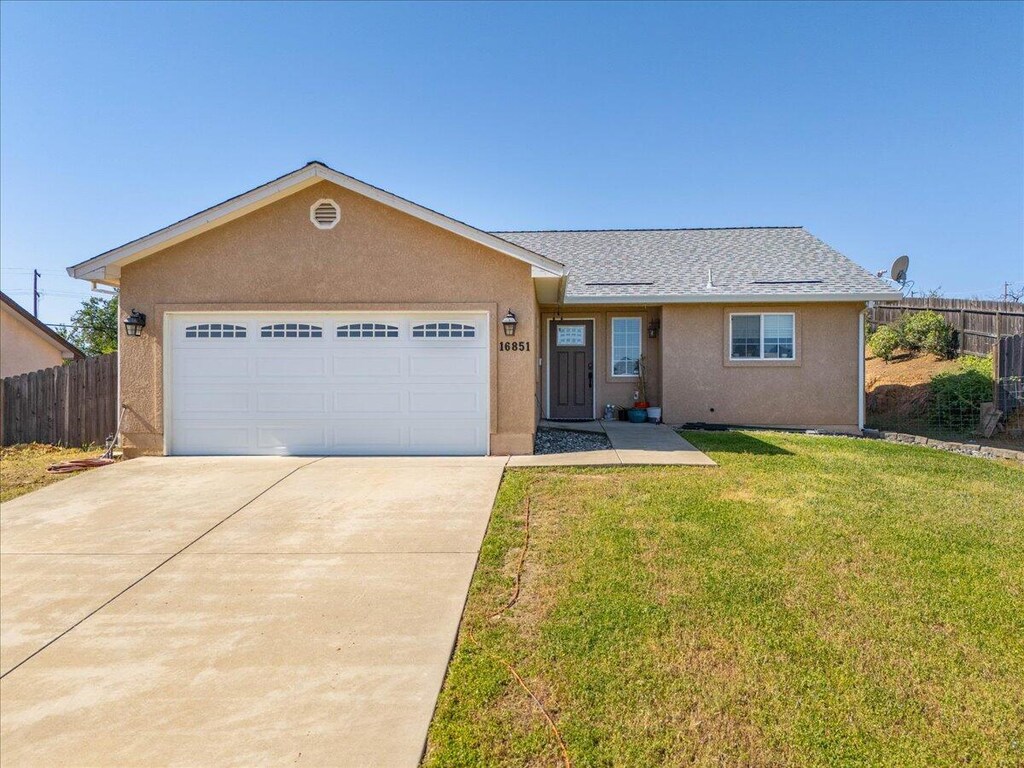 16851 Cape Cod Dr, Redding, CA 96003 - single story home with concrete driveway, stucco siding, an attached garage, and roof with shingles