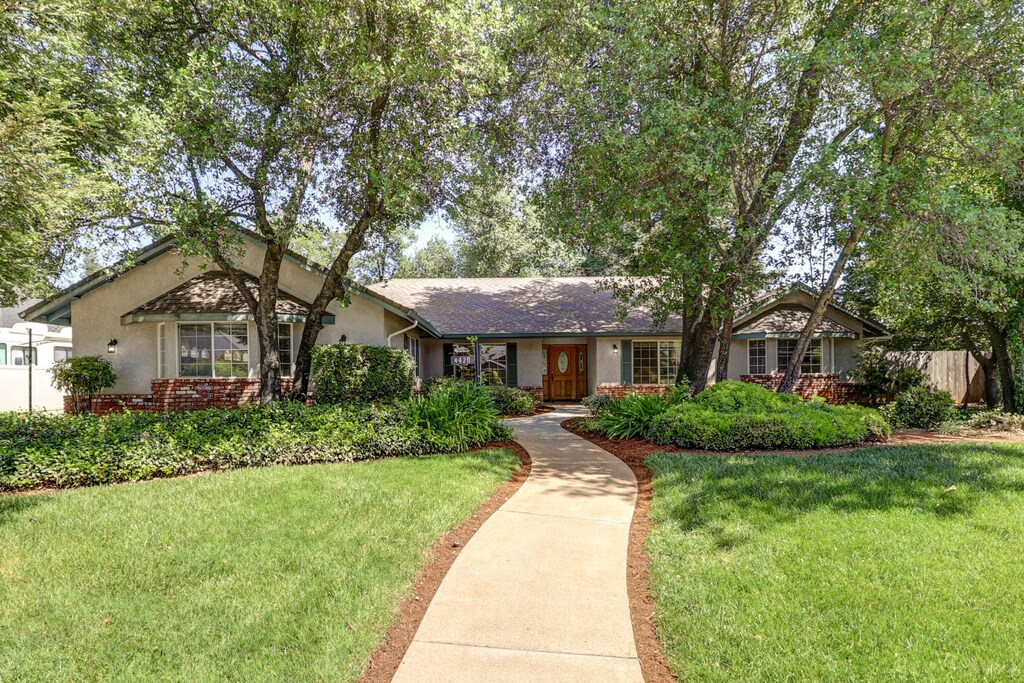 4420 Brittany Dr, Redding, CA 96002 - single story home with fence, brick siding, a front yard, and stucco siding