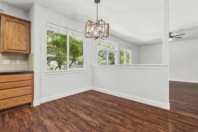 20340 Greenview Dr, Redding, CA 96002 - unfurnished dining area featuring dark wood-style flooring, baseboards, a chandelier, and a ceiling fan