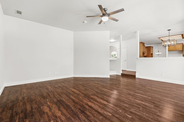 20340 Greenview Dr, Redding, CA 96002 - unfurnished living room featuring dark wood-type flooring, a chandelier, a ceiling fan, and baseboards